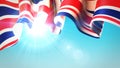 The sun shines through the waving United Kingdom flag. UK, great britain flag on blue sky for banner design. British holiday Royalty Free Stock Photo