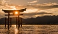 Sun shinging through the Miyajima Torii gate during sunset..Plate translation: Itsukushima Shrine