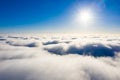 Sun shining above white clouds. Aerial cloudscape Royalty Free Stock Photo