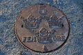 Beautiful manhole cover in the form of a five dime Royalty Free Stock Photo