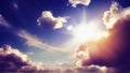 The sun is shining from behind the clouds in the blue sky. Bright sun rays shine on the clouds. International Sun Day Royalty Free Stock Photo