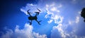 the sun is shining with the blue and white color of the clouds the drone is working to find the best objec Royalty Free Stock Photo