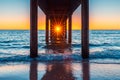 Sun shining through Brighton Jetty pylons at sunset Royalty Free Stock Photo