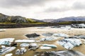 Brown Glacial waters are a stark contrast to the white ice burgs in Iceland