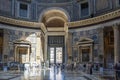 The sun shining through the hole in the roof illuminates the entrance to the Pantheon in Rome, Italy