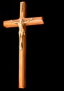 Isolated wood crucifix with golden Christ on solid black background Royalty Free Stock Photo