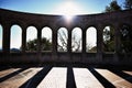 Sun shining over the arcade arch building