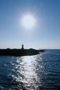 Sun shining over lighthouse