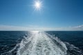 Sun shining over the wake of cruise ship at sea Royalty Free Stock Photo