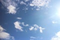 Clouds in the blue sky. Bright midday sun illuminates the space. Royalty Free Stock Photo