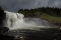 The sun shining through the Tannforsen waterfall mist