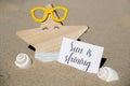 SUN IS SHINING text on paper greeting card on background of funny starfish in glasses summer vacation decor. Sandy beach Royalty Free Stock Photo