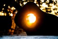 Sun shining thru the sound hole of a silhouette guitar