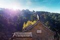 Sun shinning over a watch tower of the Mutianyu section of the Great Wall of China, surrounded by vegetation under a Royalty Free Stock Photo