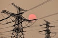 Sun in smoke haze behind electricity towers Royalty Free Stock Photo