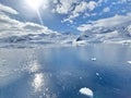 Sun, snow, water, sky in antarctica