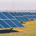 Sun and solar panels in a field. Solar energy power plant. Industrial and ecological concept for nature and eco / green technology Royalty Free Stock Photo