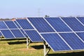 Sun and solar panels in a field. Solar energy power plant. Industrial and ecological concept for nature and eco / green technology Royalty Free Stock Photo