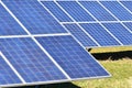 Sun and solar panels in a field. Solar energy power plant. Industrial and ecological concept for nature and eco / green technology Royalty Free Stock Photo