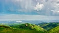 sun spots on meadow landscape with clouds. Caucasus mountains, Big Tkhach, Russia