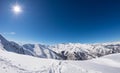 Sun star glowing over snowcapped mountain range, italian Alps Royalty Free Stock Photo