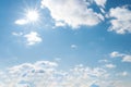 Sun with sunrays on the blue sky with white clouds. Daytime and good weather Royalty Free Stock Photo
