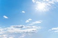 Sun with sunrays on the blue sky with white clouds. Daytime and good weather Royalty Free Stock Photo