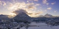 Sun at sunrise behind the Tauern mountain in snowy Reutte and Breitenwang Tyrol