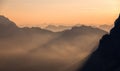 Sun at sunset between clouds and spectacular Dolomite peaks of Sella Pass, Lagazuoi, Dolomites, Italy Royalty Free Stock Photo