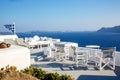 A sun terrace for rest with a white wooden table and chairs in Thira, Santorini island, Greece Royalty Free Stock Photo