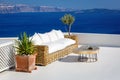 A sun terrace with sofa in Thira, Santorini island, Greece. Beautiful rest place over the caldera Royalty Free Stock Photo