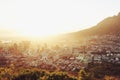 Sun, top view of city with landscape and mountains, buildings and architecture with nature outdoor. Flare, natural light Royalty Free Stock Photo