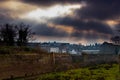 The sun trying to shine through the dramatic and dark sky during a cold winter day in Maastricht