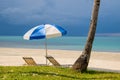 Sun umbrella and chairs on a tropical beach Royalty Free Stock Photo