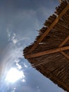 Sun umbrella made of reeds on the beach against the sky Royalty Free Stock Photo