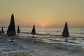 Sun umbrellas and hammocks on the beach a sunset Royalty Free Stock Photo