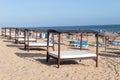 Sun umbrellas and hammocks in row for rent for tourist in Islantilla beach Royalty Free Stock Photo