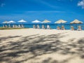 Sun umbrellas on white sand Royalty Free Stock Photo