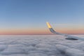 Sun at the wing of an aircraft flying in sunrise