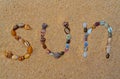 Sun written with various shells on the sand Royalty Free Stock Photo