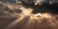 Dramatic sunbeams breaking through dark storm clouds creating bright light rays in atmospheric sky Royalty Free Stock Photo