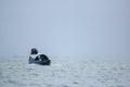 Sunamganj, Bangaldesh- October 11,2016: Lonely Passenger traveling by wooden boat in the rain