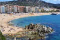 Sunbathers at Platja de Lloret beach in Lloret de Mar, Spain