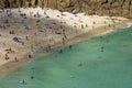 Sunbathers and swimmers on Porthcurno beach Royalty Free Stock Photo