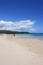 Sunbathers, swimmers and tourists on the white sand of Hapuna Beach and in the Pacific Ocean in Waimea, Hawaii