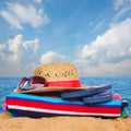 Sunbathing accessories and straw hat on sand Royalty Free Stock Photo