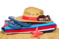 Sunbathing accessories and straw hat on sand Royalty Free Stock Photo