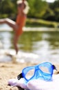 Sunbathing and splashing in the water is the best in summertime. Blue snorkel mask lies on pink towel at the beach. A happy kid Royalty Free Stock Photo