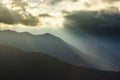 Sunbeam above mountains at sunset