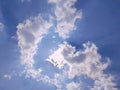 Sunbeam through the haze on blue sky. Sun light rays or beams bursting from the clouds on a blue sky. Royalty Free Stock Photo